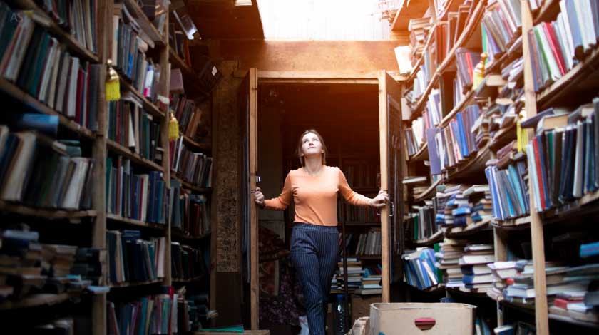 Woman Looking at Her Collection of Books