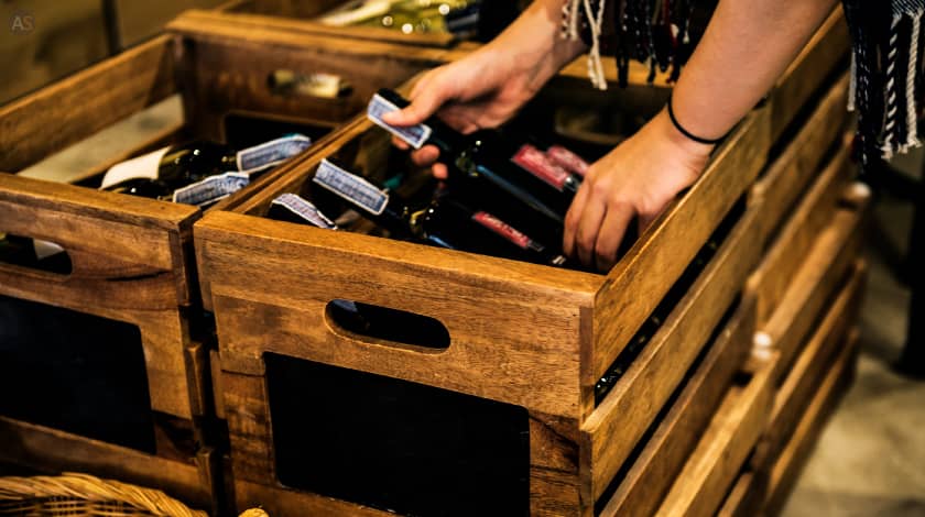 Wine bottle being packed in crate