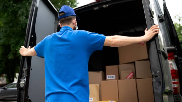 Man checking a truck loaded with packed boxes