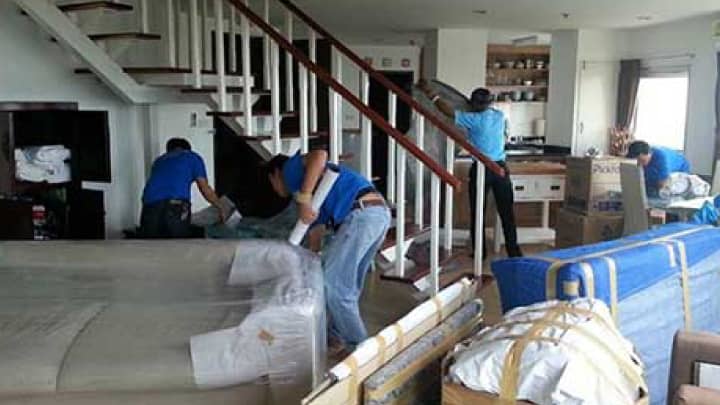 Movers packing different household items
