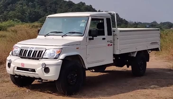 Mahindra Bolero Pickup truck stacked with household appliances and heavy furniture for a large home relocation