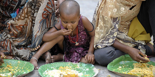 Child Eating Food Provided by Aahar Food Bank RK Foundation Bangalore” width=