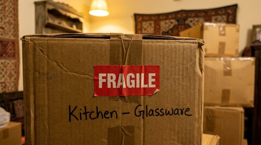Close-up of a moving box with FRAGILE labels applied to multiple visible sides