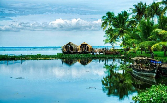 Family relaxing on the deck of a traditional houseboat cruising through Kochi's backwaters