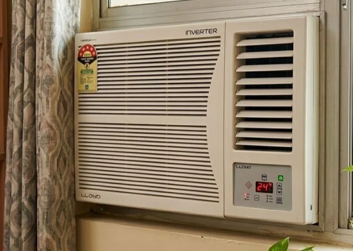 Window AC unit fitted in a wall slot in an Indian home
