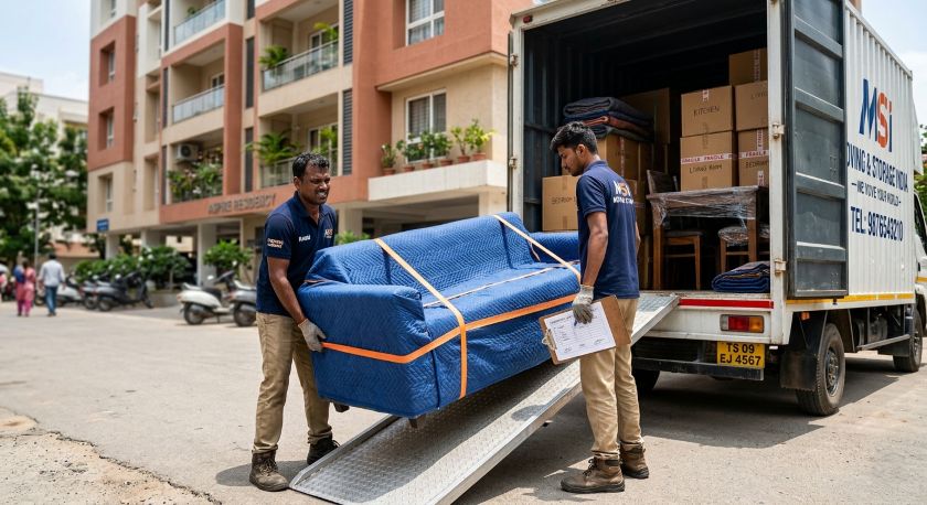 Professional packers and movers loading wrapped furniture and labeled boxes into a moving truck for Ahmedabad to Chennai house shifting